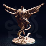 Unpainted resin miniature of Exelian the Forbidden viewed from the front — multi-armed undead horror with spread wings formed from membrane and sinew, coiled serpentine tail base, clawed hands raised, and a hooded skull-faced head, mounted on a rubble and skull-strewn scenic base