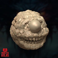 Straight-on digital render of the Eye Monger miniature showing the smooth dome-like eye at centre and the deeply pockmarked, nodular surface texture of its body, unpainted, against a dark atmospheric background