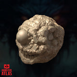Three-quarter side-angle digital render of the Eye Monger miniature revealing the full roundness of the sculpt and the uneven cratered texture across its flanks, with the single eye and toothed maw visible from the left side, unpainted