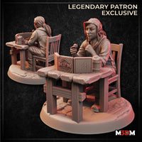 Digital render of an unpainted resin miniature showing a female Dungeon Master seated at a rustic wooden table, holding a polyhedral die in one raised hand, with an open GM screen and wooden tankard on the table. Shown from front and rear angles on an oval scenic base. Labelled as a Legendary Patron Exclusive by M3DM.