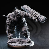 Unpainted grey resin miniature of Flim and Krim the Ettin Brute, photographed against a dark background, showing the full front view with the spiked club extended, rope-wrapped limbs, spiked knee guards, and a detailed scenic base of arena rubble and broken stone