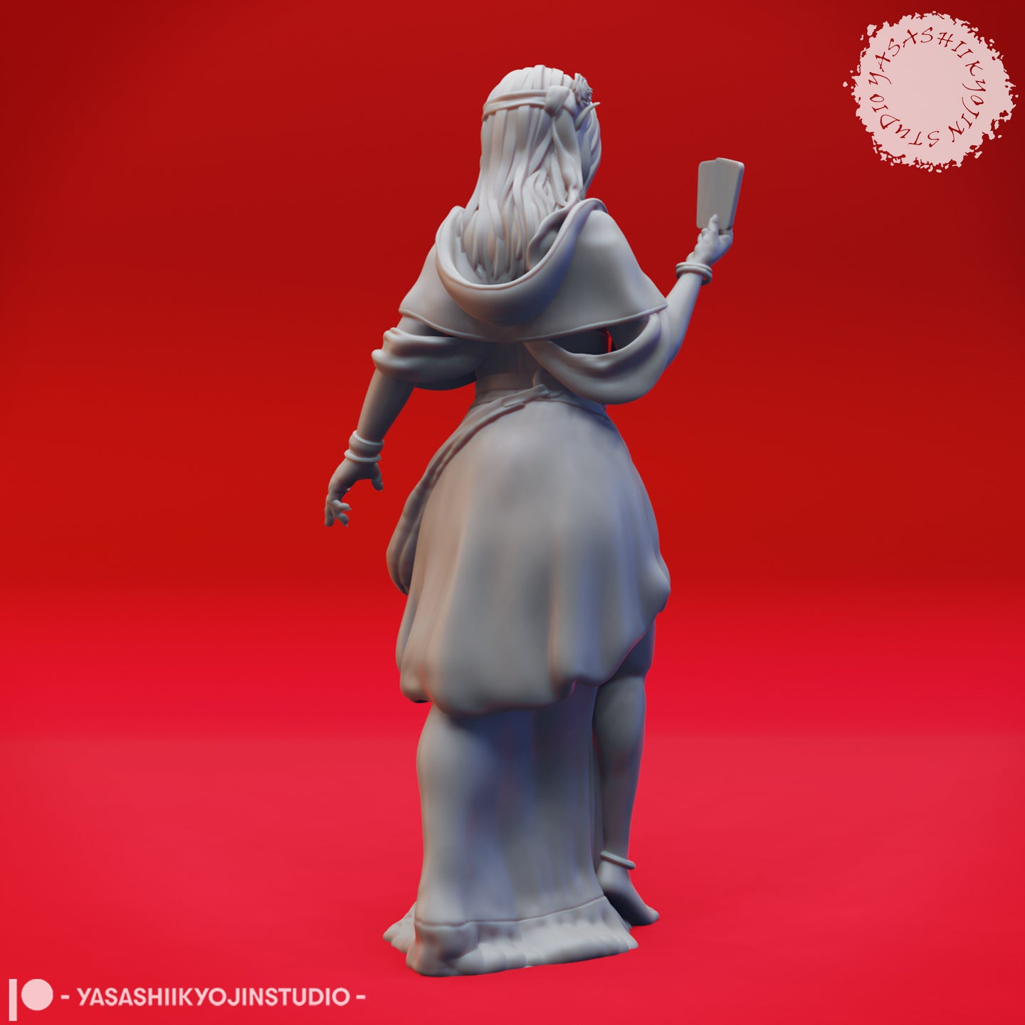 Rear view of the same unpainted grey resin female elf fortune teller miniature, showing detailed long flowing hair, a wide draped cape, and the raised tarot card visible over one shoulder, sculpted by Yasashii Kyojin Studio
