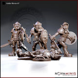 Three goblin warrior miniatures in patchwork armour and helmets — two standing with swords and shields, one lying flat on the ground, armoured and defeated, by Novaminis.