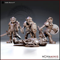 Three goblin warrior miniatures in patchwork armour and helmets — two standing with swords and shields, one lying flat on the ground, armoured and defeated, by Novaminis.