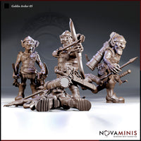 Three goblin archer sculpts by Novaminis displayed together: a standing goblin with blades and back quiver, a seated goblin drawing a longbow in heavy chain armour, and a striding goblin gripping a mace, with a fallen goblin and large mechanical weapon piece in the foreground.
