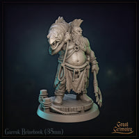 Rear view of Garruk Brinehook — showing full scaled fish detail draped over the figure's back, with fins and tail extending upward; a hooked anchor weapon visible at the hip; rope belt and tattered skirt visible below. Sculpt by Great Grimoire.