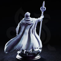 Glydnos by DM Stash — elven spellsword with swept-back hair and pointed ears, layered armour with star-motif belt buckle, billowing cloak, crescent staff raised, crystal rubble base.
