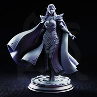 Glynaria drow priestess miniature facing forward, armoured in angular elven plate with leaf motifs, long robes billowing wide to her left, one hand raised with fingers extended, on a sculpted swirling stone base. DM Stash.