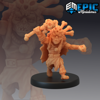Unpainted orange resin goblin shaman miniature on a black round base, posed mid-charge with a skull-topped bone club raised overhead, bones erupting from its head, snarling expression, tattered cloak billowing behind — 32mm scale tabletop miniature by Epic Miniatures