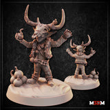 Goblin Bomber miniature by Mia Kay M3DM — small goblin in layered robes wearing a horned bull skull mask, arms spread wide clutching round bombs in both fists, spare flasks at its feet on a snow-covered scenic base.