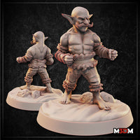 Muscular bald goblin with a curling moustache, fists raised in a fighting stance, wearing frilled fabric cuffs at wrists and ankles, standing barefoot on a rocky scenic base. Sculpt by Mia Kay M3DM.