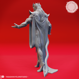 Rear three-quarter view of Graz'zt miniature highlighting the full sweep of his long cape, the backs of the skull shoulder armour pieces, flowing white hair, and the open-handed gesture of the extended right arm. Unpainted grey resin render by Yasashii Kyojin Studio.