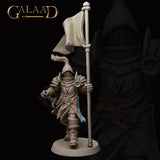 Front view of an unpainted grey resin 32mm knight miniature from Galaad Miniatures — Queen's Guard 01 — showing full ornate plate armour with crested visor helm, floral pauldron detail, laminar leg armour, swept battle skirt, and a tall standard banner held in the right hand, striding forward on a round base