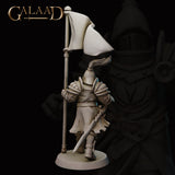 Rear three-quarter view of the unpainted grey resin Queen's Guard 01 miniature by Galaad Miniatures, showing the back of the crested helm with flowing plume, detailed heraldic shoulder armour, a short sword drawn at the hip, and the full banner pole, on a round base