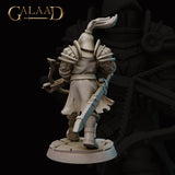Rear view of Queen's Guard 02 miniature by Galaad Miniatures — unpainted grey resin showing detailed knotwork pauldron reliefs, swept plume on the visored helm, the crossbow stock visible at the side, flowing tabard and articulated leg armour, cobblestone base, 32mm scale