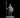 Grey resin digital render of a male guard miniature at 32mm scale, standing upright in chainmail armour with a kettle helm, holding a long spear in his right hand and a round shield in his left, mounted on a round base