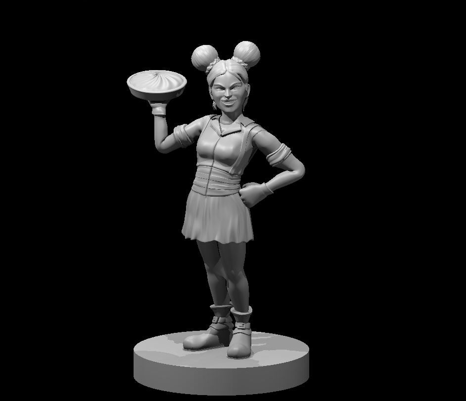Unpainted grey resin miniature of a halfling female bard, standing confidently with one hand on her hip and the other raised to balance a platter with a dumpling. She wears a layered outfit with wrapped boots and her hair is styled in two round bun-knots. Sculpted at 32mm scale on a round base.