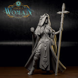 Grey resin hexblood cleric with small curved horns beneath a large hood, long flowing hair, wide-sleeved robes with crescent moon and pentagram embossing, raising one hand with spread fingers while holding a cross-tipped staff. Sculpt by DnD Is A Woman.