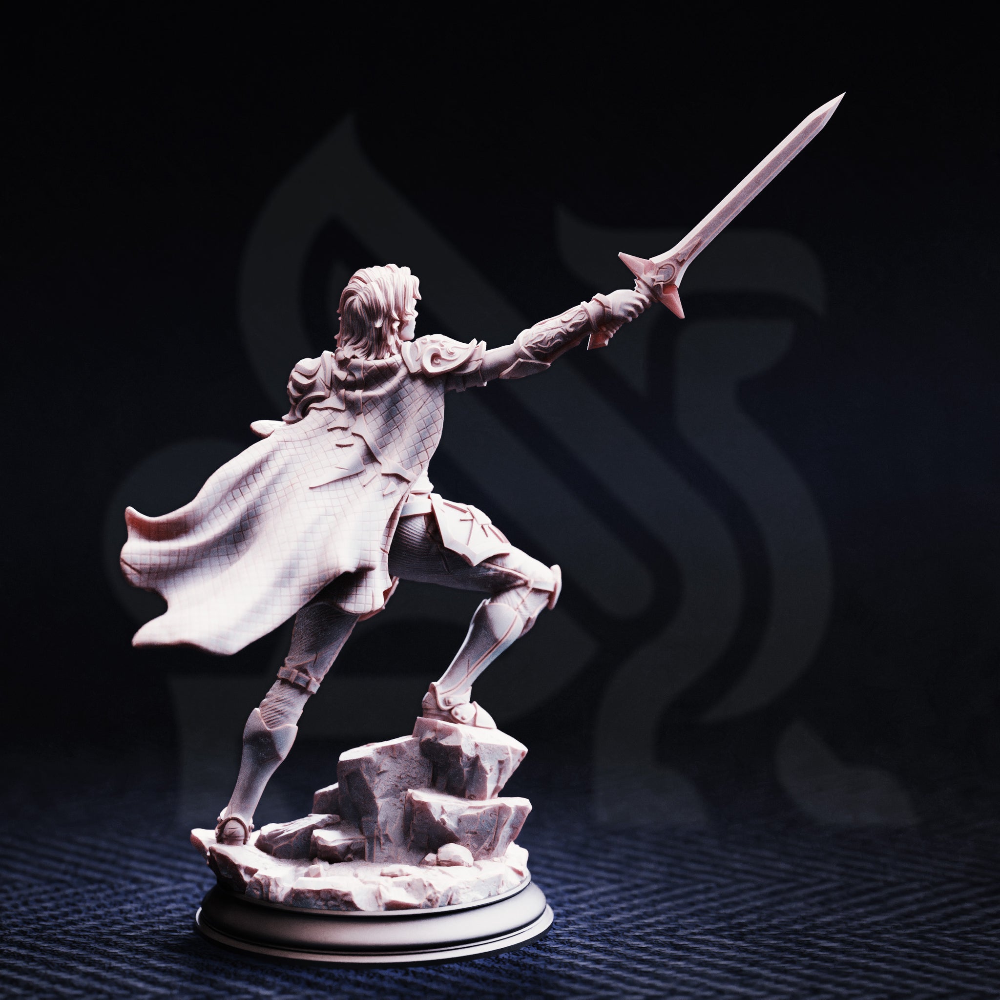 Unpainted grey resin miniature of Hitalia, Paladin of Glanion, photographed from behind against a dark background — revealing the diamond-grid texture of her billowing cloak, engraved back armour detailing, and the full extent of her raised long sword, mounted on a scenic rocky rubble base