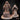 Unprinted grey resin render of the Holy Sister Priestess miniature showing front and rear views — a robed female figure with long flowing hair, a skull-sun emblem belt, chains around her body, arms outstretched with open palms, standing over a detailed ritual chest base ringed with candles