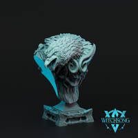 Digital render of the Hydra Sphinx Head Bust by Witchsong Miniatures — an unpainted grey resin display bust featuring a fierce eagle-headed sphinx face with a hooked beak, dense layered feather crest, curling ram-style horns, and a skull-like lower jaw, mounted on a square ornate stone plinth with geometric relief detailing, shown against a dark background