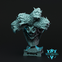 Digital render of the Hydra Sphinx Multi-Head Bust by Witchsong Miniatures — an unpainted grey resin display bust showing a central snarling humanoid face flanked by two wolf-like beast heads and two horned demonic visages, all emerging from a dense mass of feathers and scales, mounted on a sculpted scroll-work plinth
