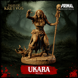 Ukara the swamp witch 32mm resin miniature — front view, lunging pose with clawed hand outstretched, mouth open in a curse, skull-topped skeleton staff in right hand, base scattered with skulls and marsh roots, unpainted tan resin, Tales of Kreyvos by Primal Collectibles