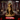 Queen Elyndra miniature standing upright, wearing flowing robes with a high slit, ornate pauldrons, a jewelled chest medallion, and a leaf-pattern belt. Long wavy hair crowned with a circlet. Primal Collectibles.