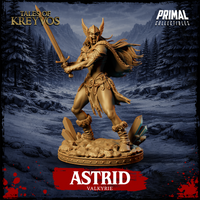 Front view of Astrid the Valkyrie 32mm resin miniature — unpainted gold render showing winged helm, longsword raised in battle cry, feathered cloak, ornate belt, and crystal-strewn skull base from the Tales of Kreyvos range by Primal Collectibles