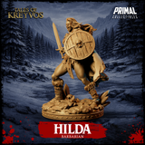 Hilda Barbarian 32mm miniature by Primal Collectibles — side-on charging pose, skull-bossed shield thrust forward, sword drawn back, hair and cloak streaming behind her, golden resin render, scenic rubble base
