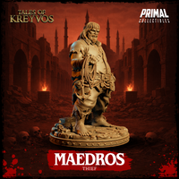 Maedros the Thief facing right — burly rogue with long hair and beard, rope and grappling hook in one hand, opposite arm relaxed at side, standing on a broken-stone rubble base. Sculpt by Primal Collectibles.