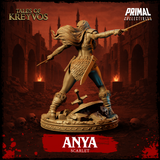 Anya Scarlet barbarian by Primal Collectibles: elevated view looking down across outstretched spear arm, hair swept back, scale-mail and bare midriff visible, scattered skulls and stone fragments on the scenic base.