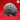 Front view of an unpainted grey resin render of the Intellect Devourer 02 miniature by Yasashii Kyojin Studios, showing a large brain-shaped creature body with deep cerebral folds, four splayed clawed feet, and a small curling tail, set against a red background