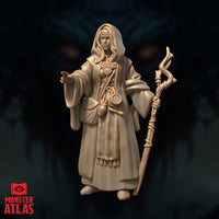 Front-facing digital render of Jallarzi Sallavarian miniature — a hooded robed female arcane scholar holding a gnarled twisted staff in her right hand, left hand extended with fingers poised mid-gesture, ornate brooch at chest and small vials at belt, unpainted warm beige resin finish, 32mm scale by Monster Atlas