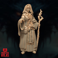 Close-up front digital render of Jallarzi Sallavarian miniature emphasising facial detail — sharp focused expression beneath a cloth headband, long hair framing the face, ornate brooch on chest clearly visible, staff held to one side and right hand reaching forward, unpainted warm beige resin finish by Monster Atlas