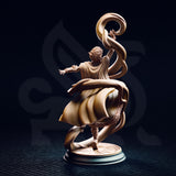 Rear view of the Juri the Lightdancer miniature — showing the back of the female elf sorceress with curly hair, sweeping cloak and robes in motion, raised arm holding a spiralling magical ribbon, and the ornately engraved sunburst base detail clearly visible