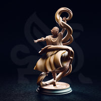 Rear view of the Juri the Lightdancer miniature — showing the back of the female elf sorceress with curly hair, sweeping cloak and robes in motion, raised arm holding a spiralling magical ribbon, and the ornately engraved sunburst base detail clearly visible