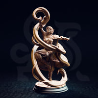 Front view of the unpainted Juri the Lightdancer resin miniature — female elf sorceress in a dynamic casting pose with dramatic flowing magical ribbons curling upward from her raised hand, detailed carved beltwork and layered skirts visible, on a sculpted sunburst base against a dark background