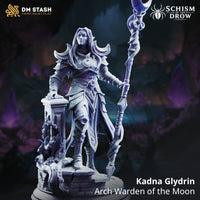 Rear view of Kadna Glydrin by DM Stash — flowing hair and cloak visible, crescent-moon staff raised high, back detailing on layered armour and skirt panels, ruined pillar base with organic vine growth.