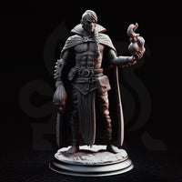 Male warlock miniature with braided white hair, spiked forearm wraps, and a skull-clasp cloak, holding conjured flame aloft and dangling a knotted effigy by its hair at his side. Sculpt by DM Stash.