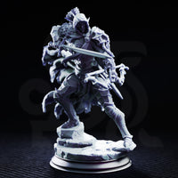 Hooded drow ranger striding forward with longsword levelled in one hand and a bone-tipped rod in the other, wearing skull-adorned pauldrons and a billowing tattered cloak. Sculpt by DM Stash.