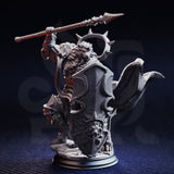 Close-up photograph of the unpainted grey resin Kigari Solheart miniature against a dark background, showing the front and shield side of the sculpt. The lion's-head embossed tower shield and dynamic cloak are prominent, with fine armour engraving visible across the pauldrons and chest. The spear is raised diagonally overhead and the rubble-strewn base is clearly visible.