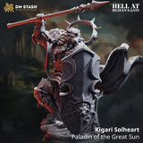 Digital render of Kigari Solheart, an unpainted grey Leonin Paladin miniature from DM Stash's Hell at Heaven's Gate collection, shown three-quarter front view. He wears heavily engraved plate armour and carries a large tower shield bearing a lion's-head relief, whilst his right arm is raised overhead gripping a long spear. A thorned halo crown rises behind his maned leonine head. Text on the image reads 'Kigari Solheart, Paladin of the Great Sun'.