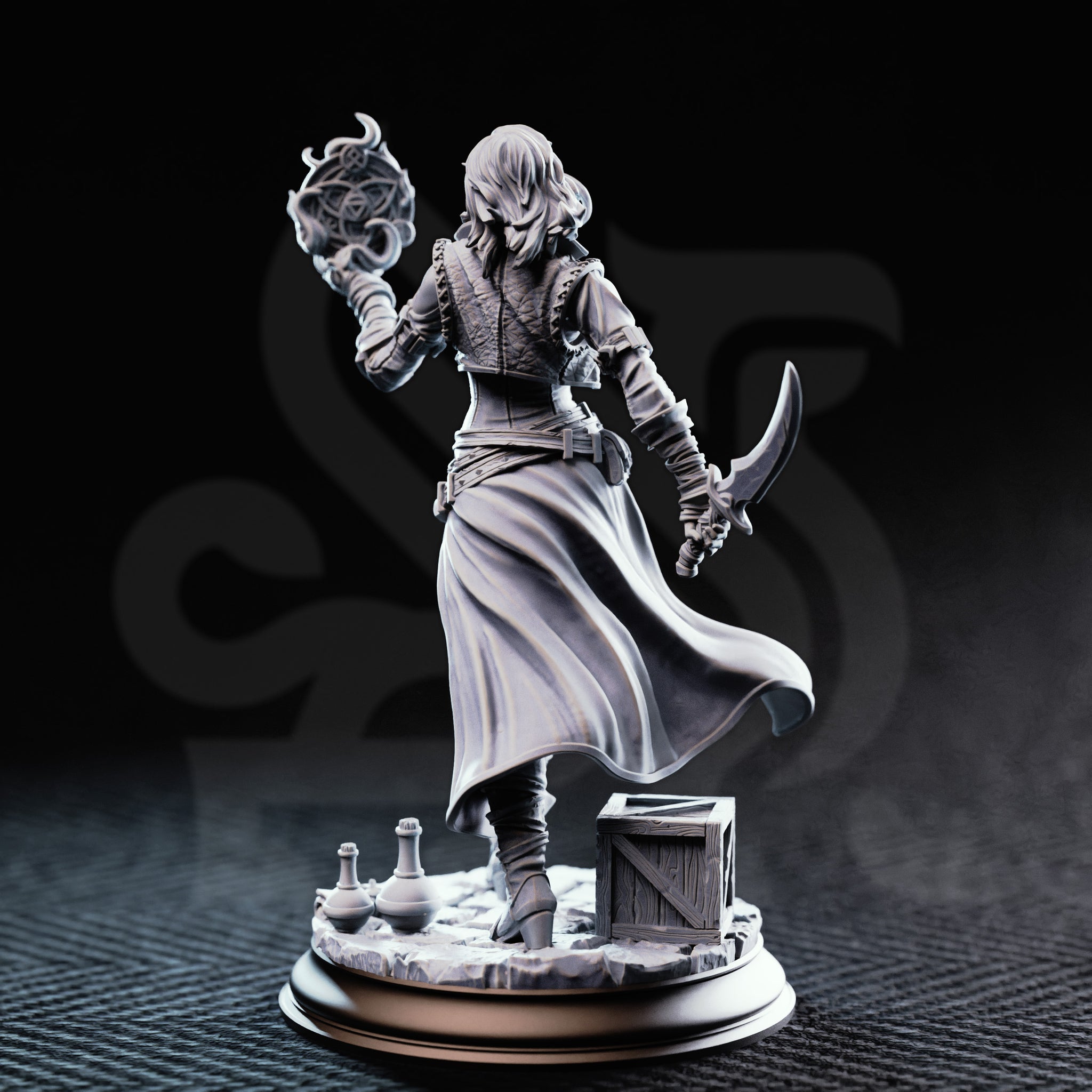 Photograph of printed unpainted grey resin Kira Solseth miniature by DM Stash — rear three-quarter view showing billowing long coat, back detail of armour and belt straps, raised arcane orb, and curved blade at her side, with crate and potions on the scenic base