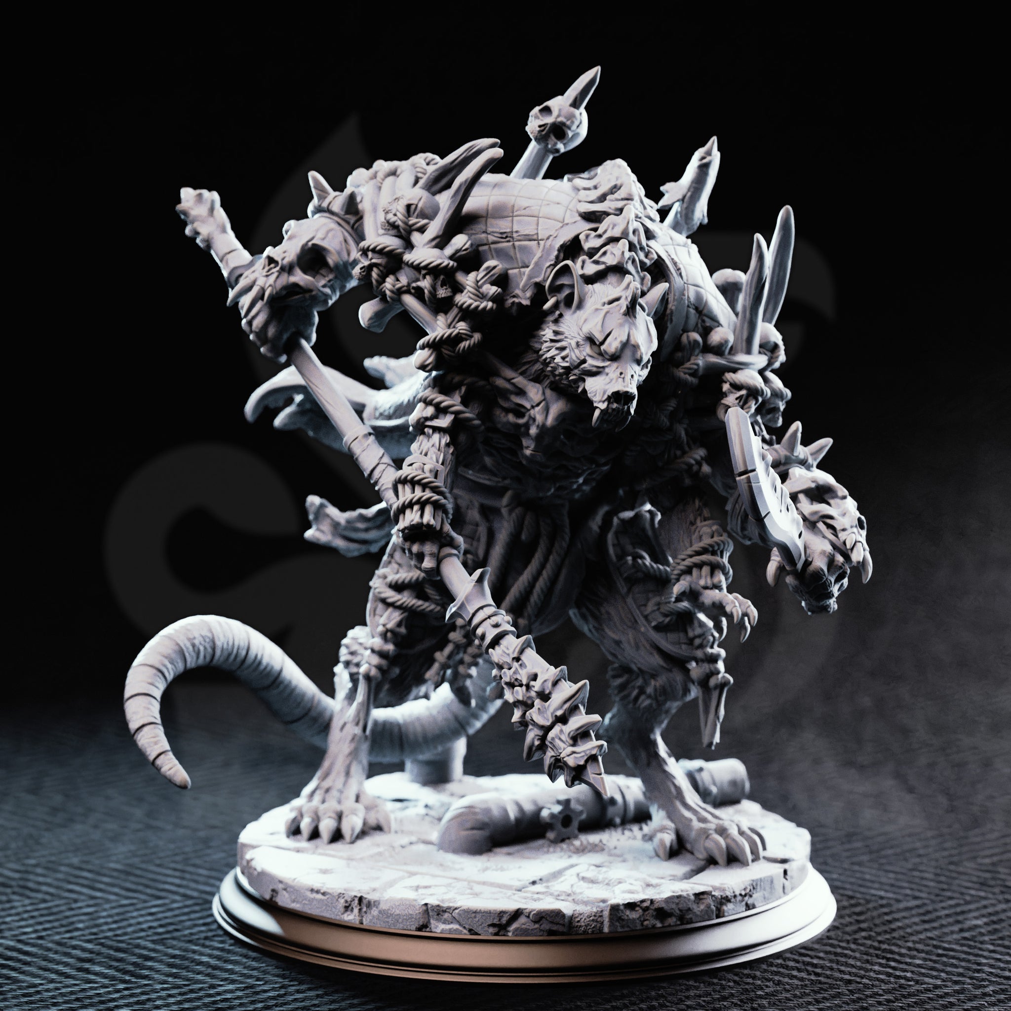 Unpainted grey resin Rat King miniature by DM Stash — front view showing multiple snarling rat heads, looted weapons including a skull-tipped staff, thick ringed tail, and layered scale-and-fur textures on a detailed rubble base