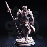 Front view of an unpainted grey resin 32mm miniature of Krunthar — a half-orc knight in layered plate armour with a heraldic breastplate sigil and cross-belt detailing, wielding an ornate warspear, standing on a sculpted rubble base with a broken sword beneath his feet.