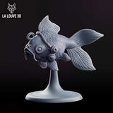 Chubby fantail fish miniature with wide round eyes and downturned mouth, adorned with small hanging bells and fine scale detail, mounted on a slender pedestal base. Sculpt by La Louve 3D.