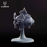 Rotund fish miniature viewed from behind, showing twisted rope bindings looped around its body with bells attached, broad swept fins and a split fantail with fine vein detail. Sculpt by La Louve 3D.