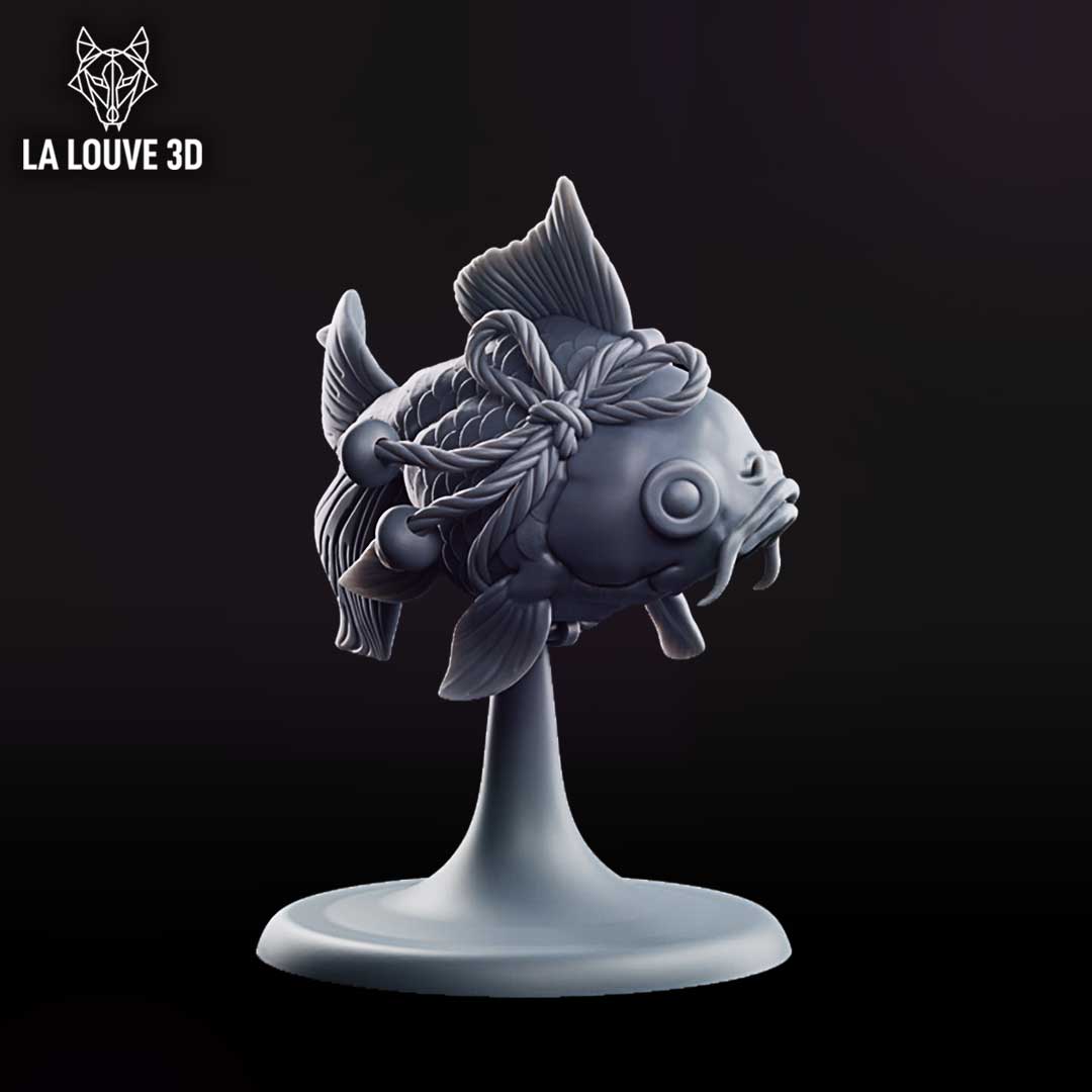 Rotund fish miniature viewed from behind, showing twisted rope bindings looped around its body with bells attached, broad swept fins and a split fantail with fine vein detail. Sculpt by La Louve 3D.