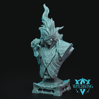 Unpainted cyan resin display bust of the Left Hand of Lilith by Witchsong Miniatures — a blindfolded female warrior in ornate angular armour with a crown of sculpted flame rising above her head, holding a skull in one gauntleted hand, mounted on a detailed stone plinth base